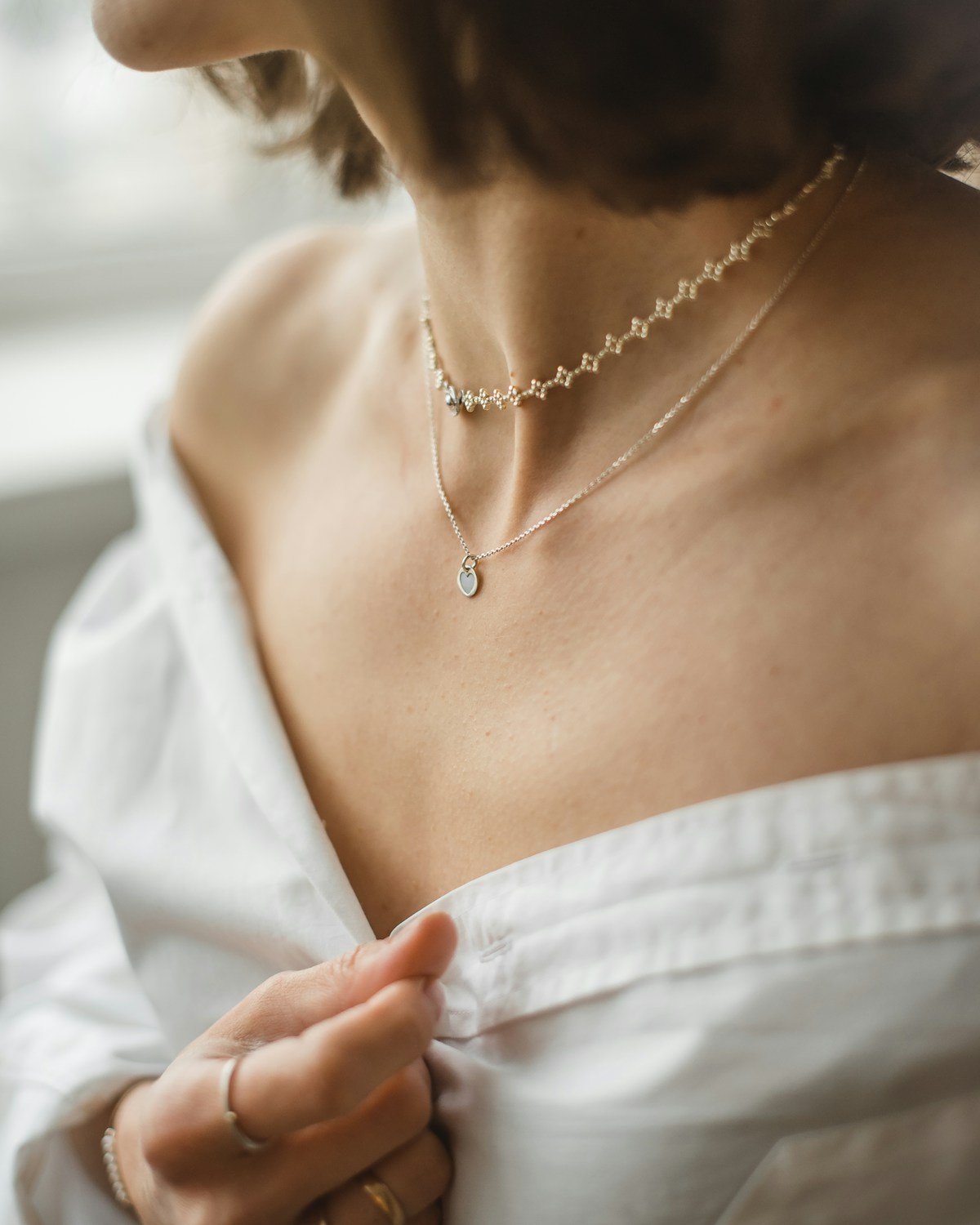 A fine gold chain resting at the collarbone