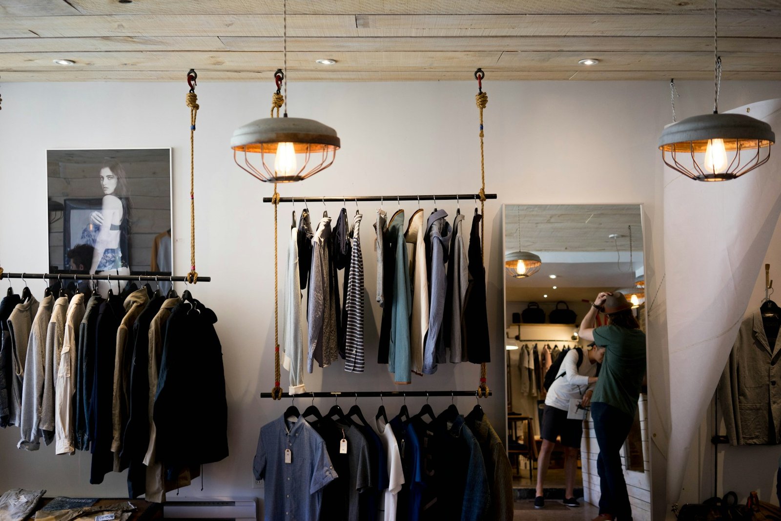 Inside the OFFICE EDIT studio, rails of clothing under warm light