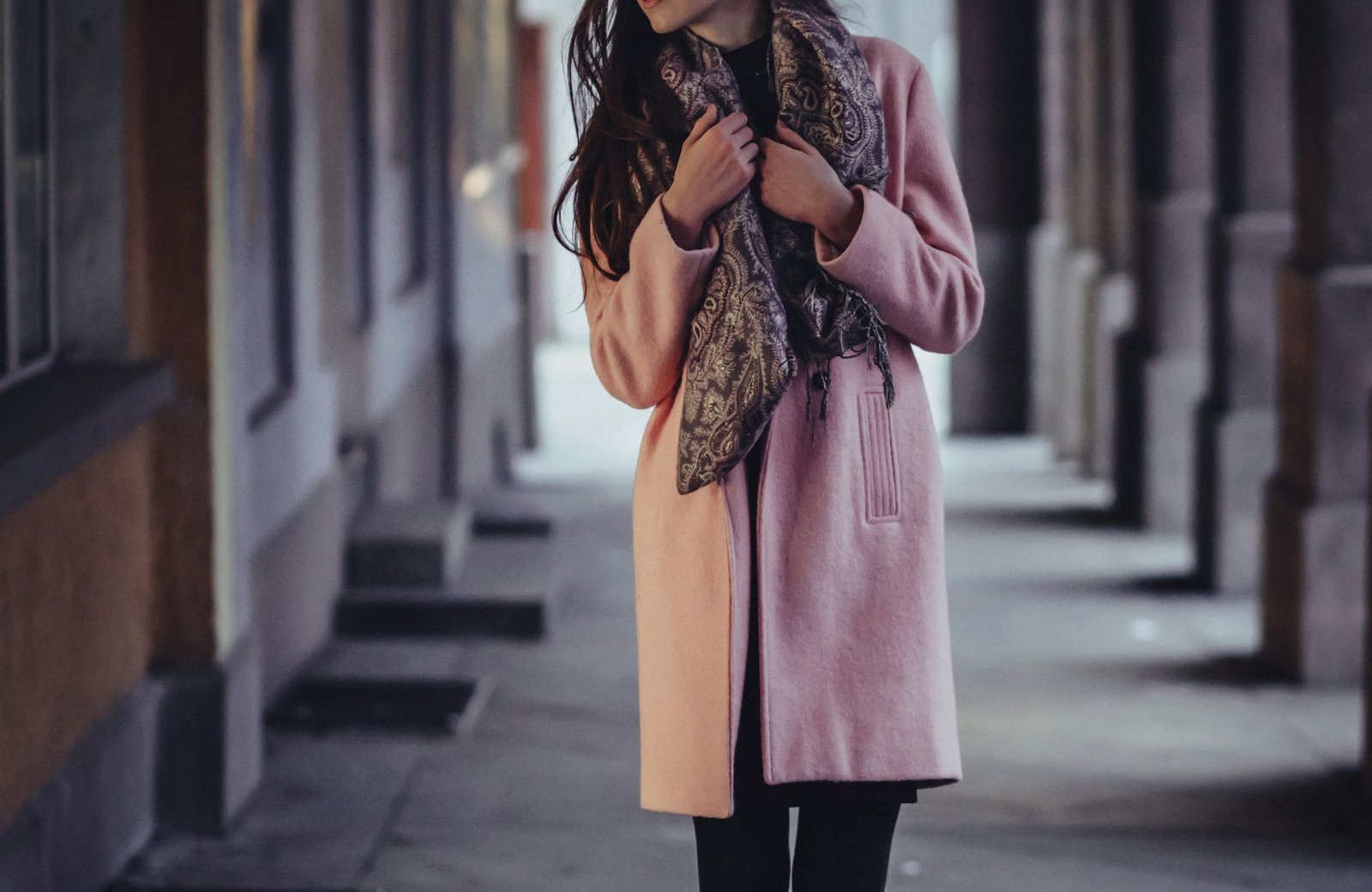 A long coat in a stone corridor