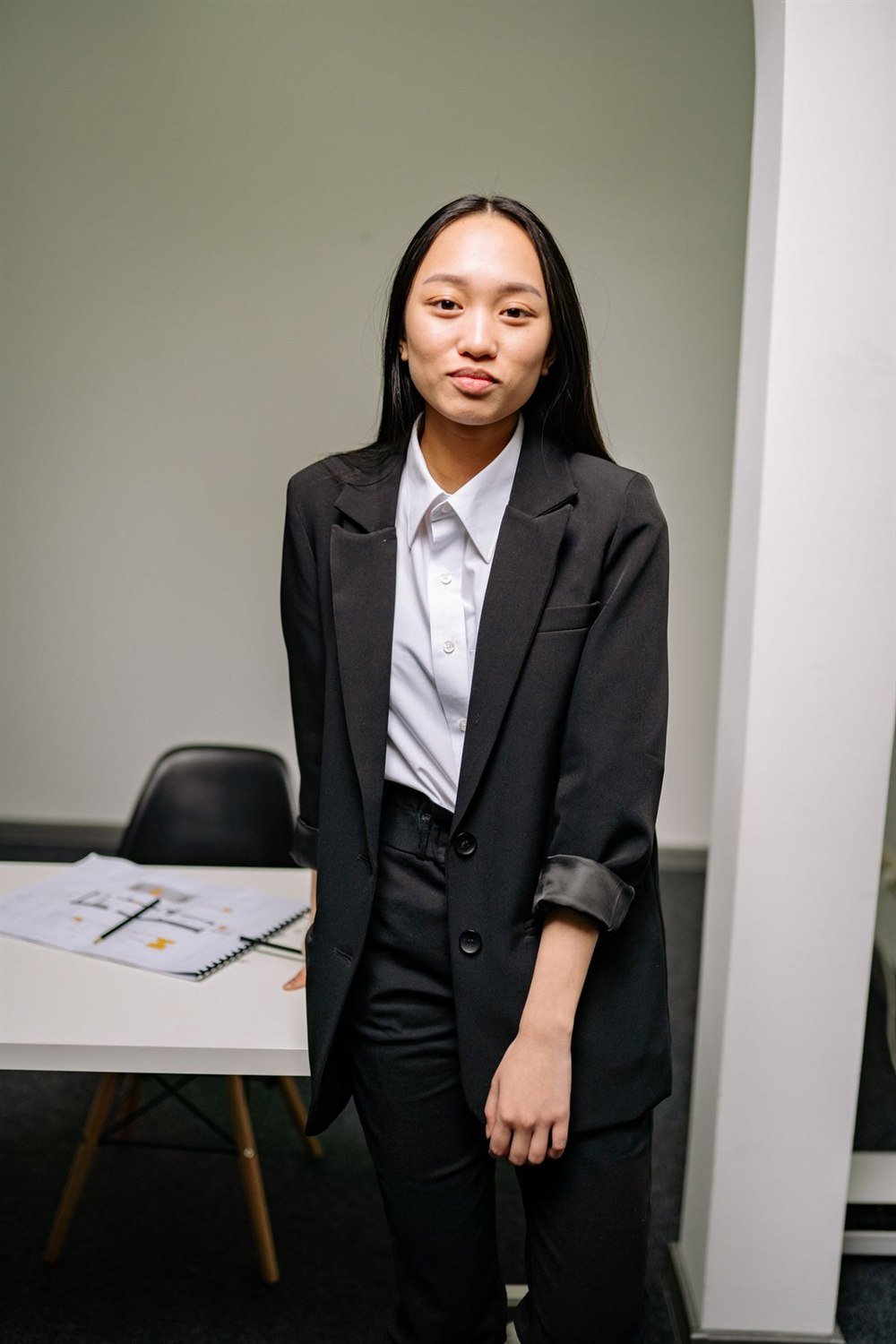 A black tailored suit worn with a white shirt